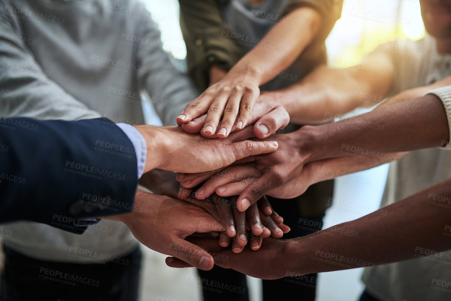 Buy stock photo Cropped shot of a group of businesspeople joining their hands in solidarity