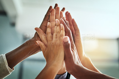 Buy stock photo Hands, huddle and high five while a group of diverse businesspeople celebrate and motivate each other at the workplace. Colleagues winning and achieving success through teamwork and collaboration