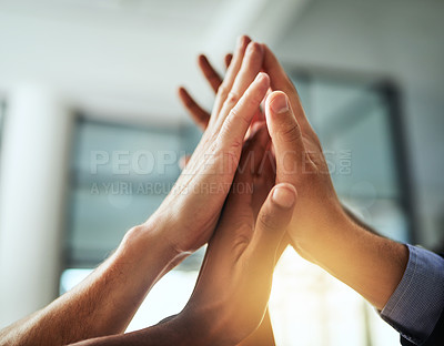 Buy stock photo High five of a diverse group of businesspeople celebrate, unite and support each other. Closeup of a multiethnic corporate professional team hands touching showing success inside a startup office