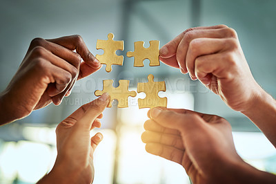 Buy stock photo Teamwork, unity, collaboration by a group of business people completing a puzzle together, innovation and strategy. Closeup of hands planning, sharing a goal or vision while joining in success