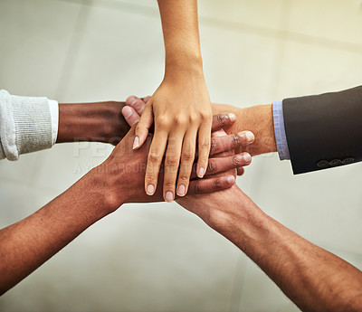 Buy stock photo Hands of business people stacked together in group for unity, teamwork and motivation. Team of office workers, employees and colleagues piling and stacking hands for support, trust and victory