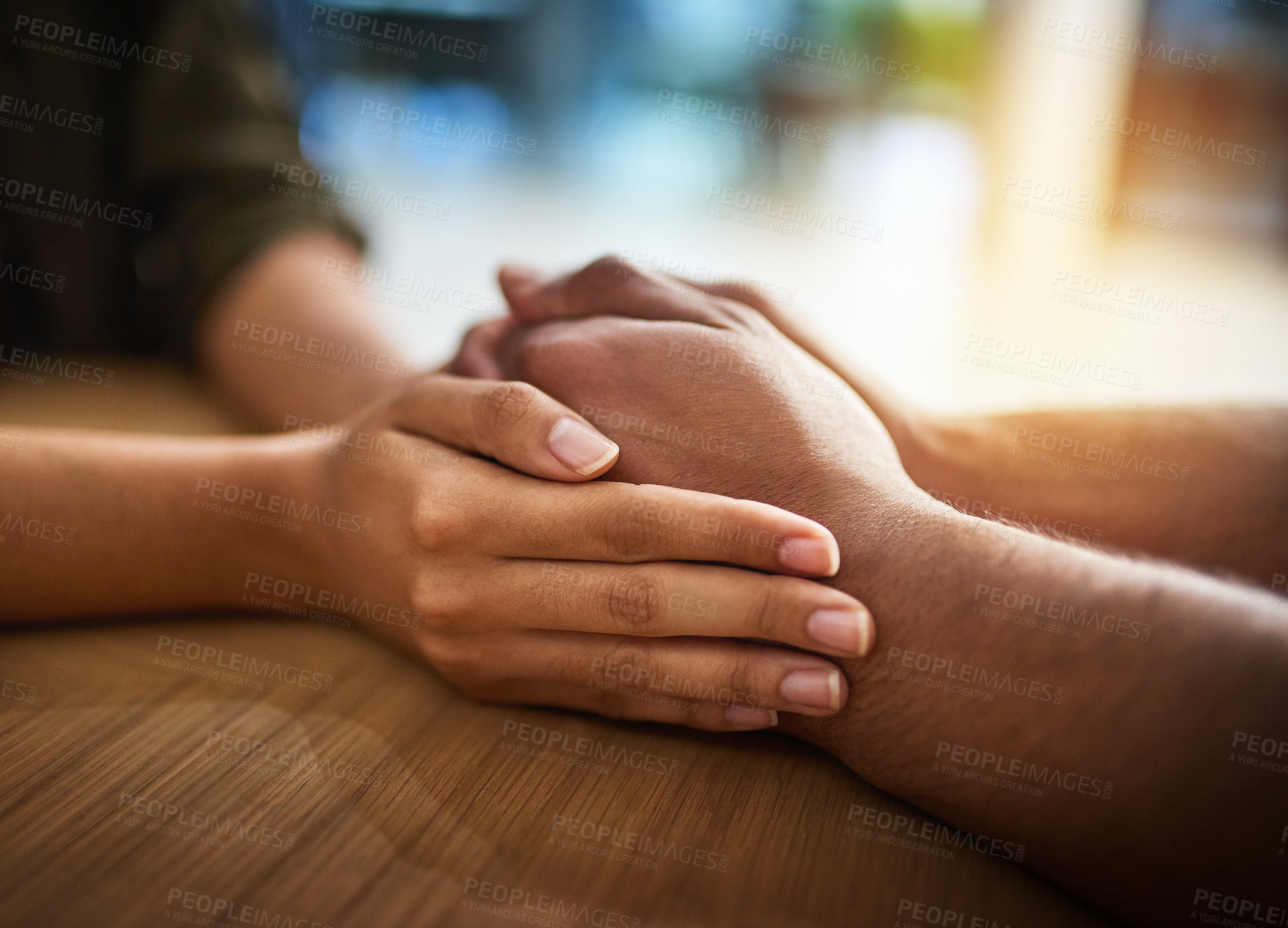 Buy stock photo Romantic, caring and in love couple holding hands, wife expressing sympathy and showing support. Female apologizing, comforting or calming upset male on the table at home. 