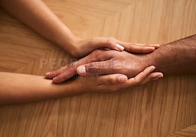 Buy stock photo Holding hands in love and support, showing care, comfort and consoling a friend. Two people together in unity, solidarity and trust, showing hope, faith and kindness while helping and bonding closeup