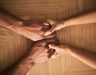Buy stock photo Man and woman holding hands on a table and supporting, helping and comfort each other in marriage couple  counseling session from above view. Loving husband and wife touching each other showing care
