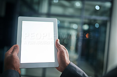 Buy stock photo Man holding tablet in hand with blank screen over a isolated copy space background. Closeup of businessman hands on a digital tablet in a modern office working late at night.