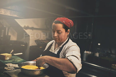 Buy stock photo Shot of a focused chef preparing a dish in the kitchen of a restaurant