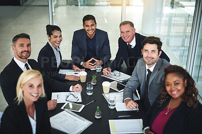 Buy stock photo Portrait of a group of businesspeople having a meeting together while looking into the camera in a boardroom at the office