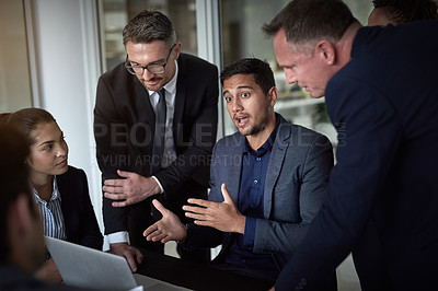 Buy stock photo Shot of a group of businesspeople having a meeting together over a laptop in a boardroom at the office