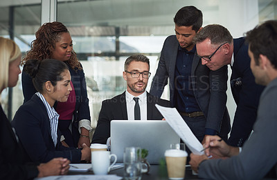 Buy stock photo Shot of a group of businesspeople having a meeting together over a laptop in a boardroom at the office