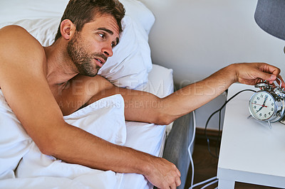Buy stock photo Shot of a handsome young man waking up at home