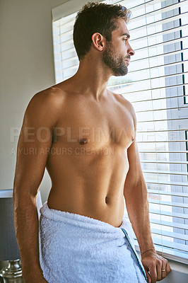 Buy stock photo Shot of a handsome young man in a towel at home