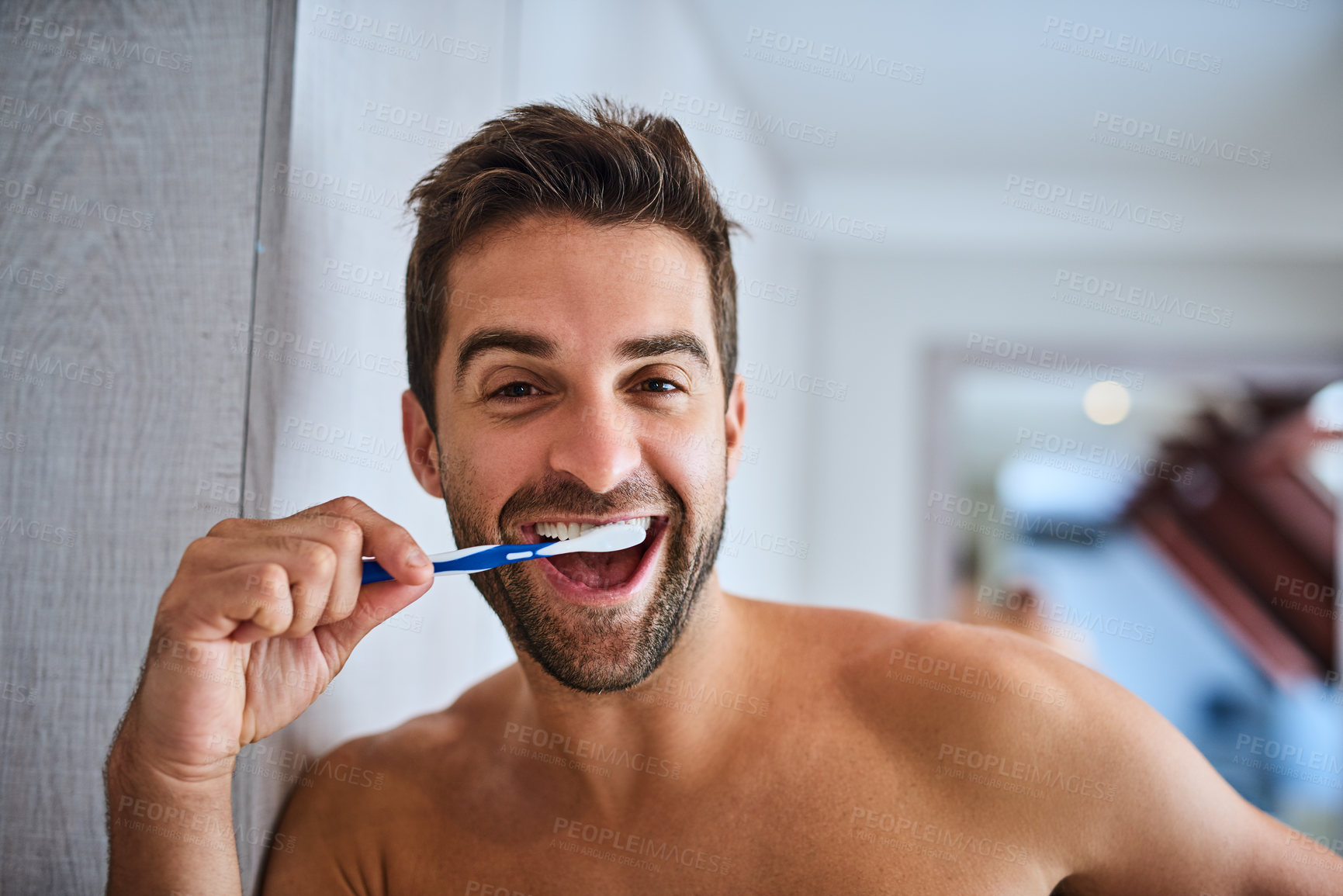 Buy stock photo Portrait, toothbrush and face of happy man brushing teeth in home for dental wellness, healthy habit and gums. Excited guy cleaning mouth for fresh breath, oral hygiene or morning routine in bathroom