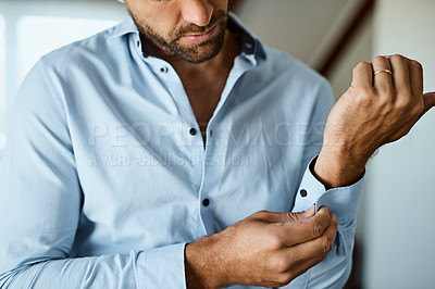 Buy stock photo Shot of an unrecognizable man dressing himself at home