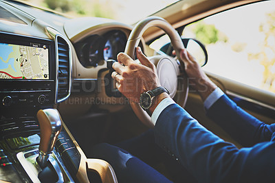 Buy stock photo Shot of a unrecognizable businessman driving in his car on his way to work
