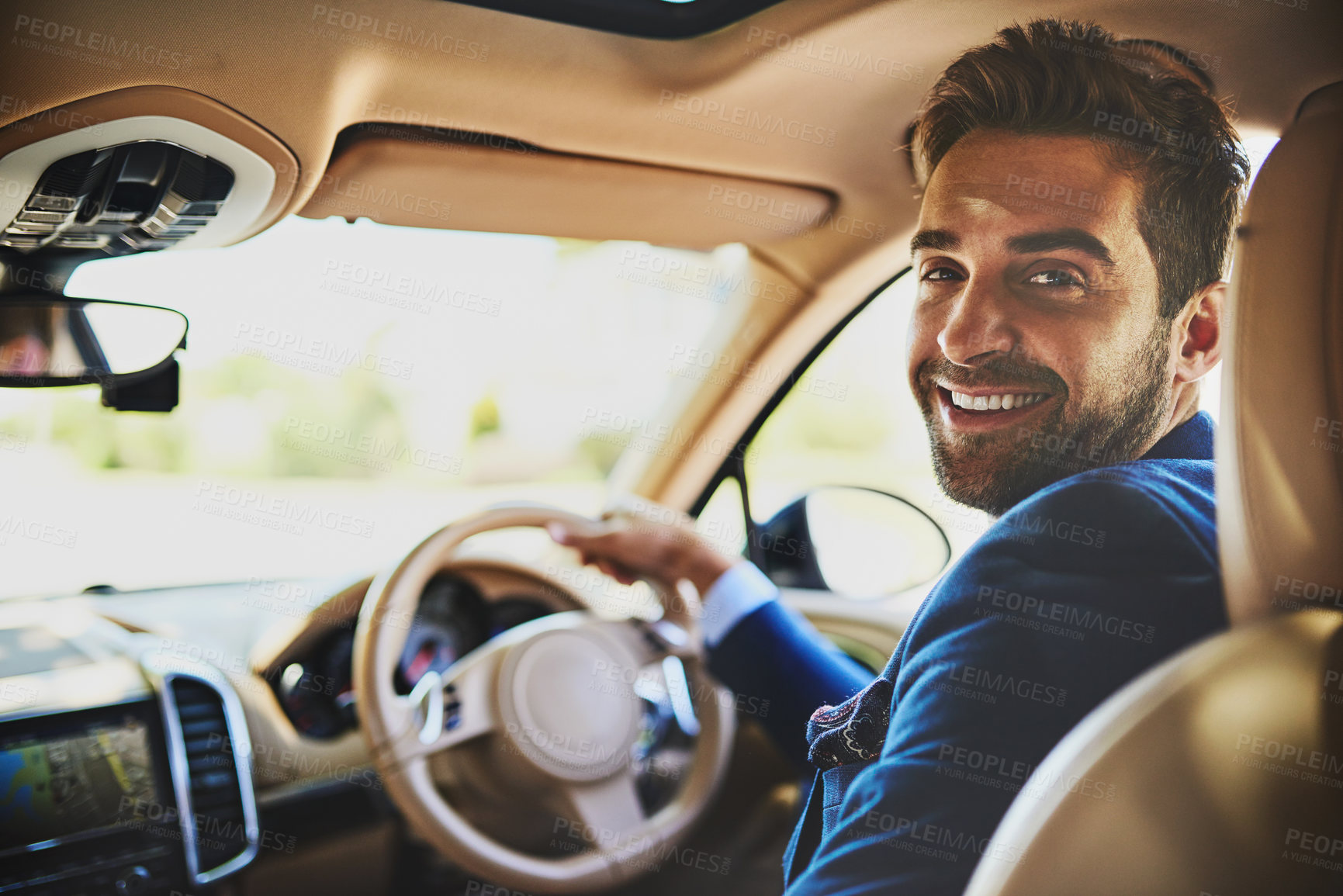 Buy stock photo Portrait of a cheerful young businessman driving in his car to work while sitting in traffic and looking into the camera