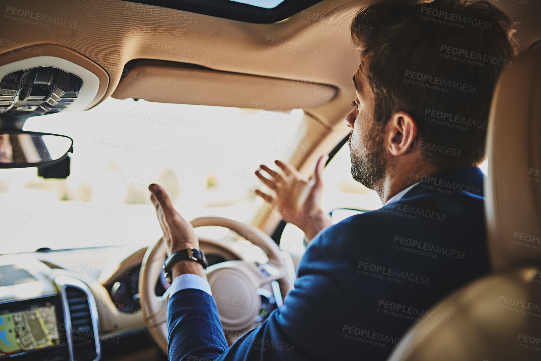 Buy stock photo Shot of a stressed young businessman holding up his hands in frustration while driving in his car and sitting in traffic