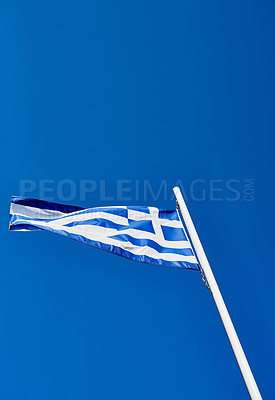 Buy stock photo Low angle shot of the Greek flag standing on its own outside during the day