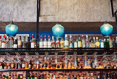 Buy stock photo Shot of an immaculate bar with many bottles and glasses with no people