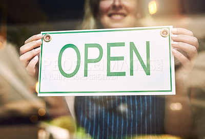Buy stock photo Shot of a woman putting up a open sign in a bar