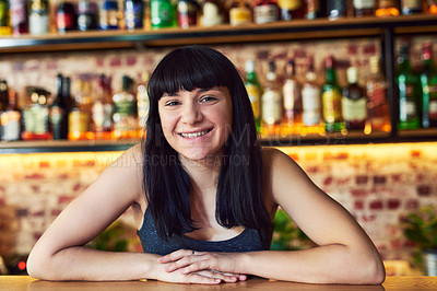 Buy stock photo Cropped shot of a waitress standing behind the counter at a bar