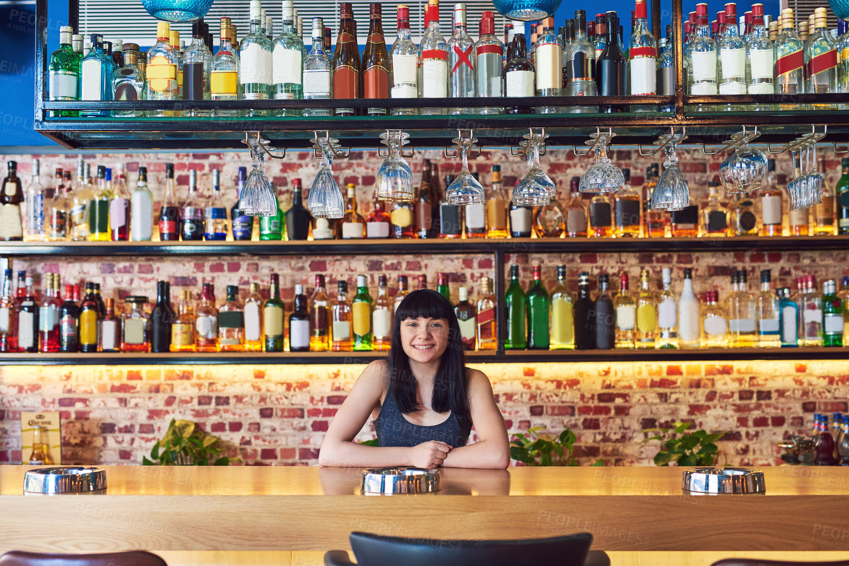 Buy stock photo Small business, woman and happy at pub as bartender on portrait with confidence and proud. Female person, bar and smile on growth, progress and satisfied as waitress or barista for ownership in Spain