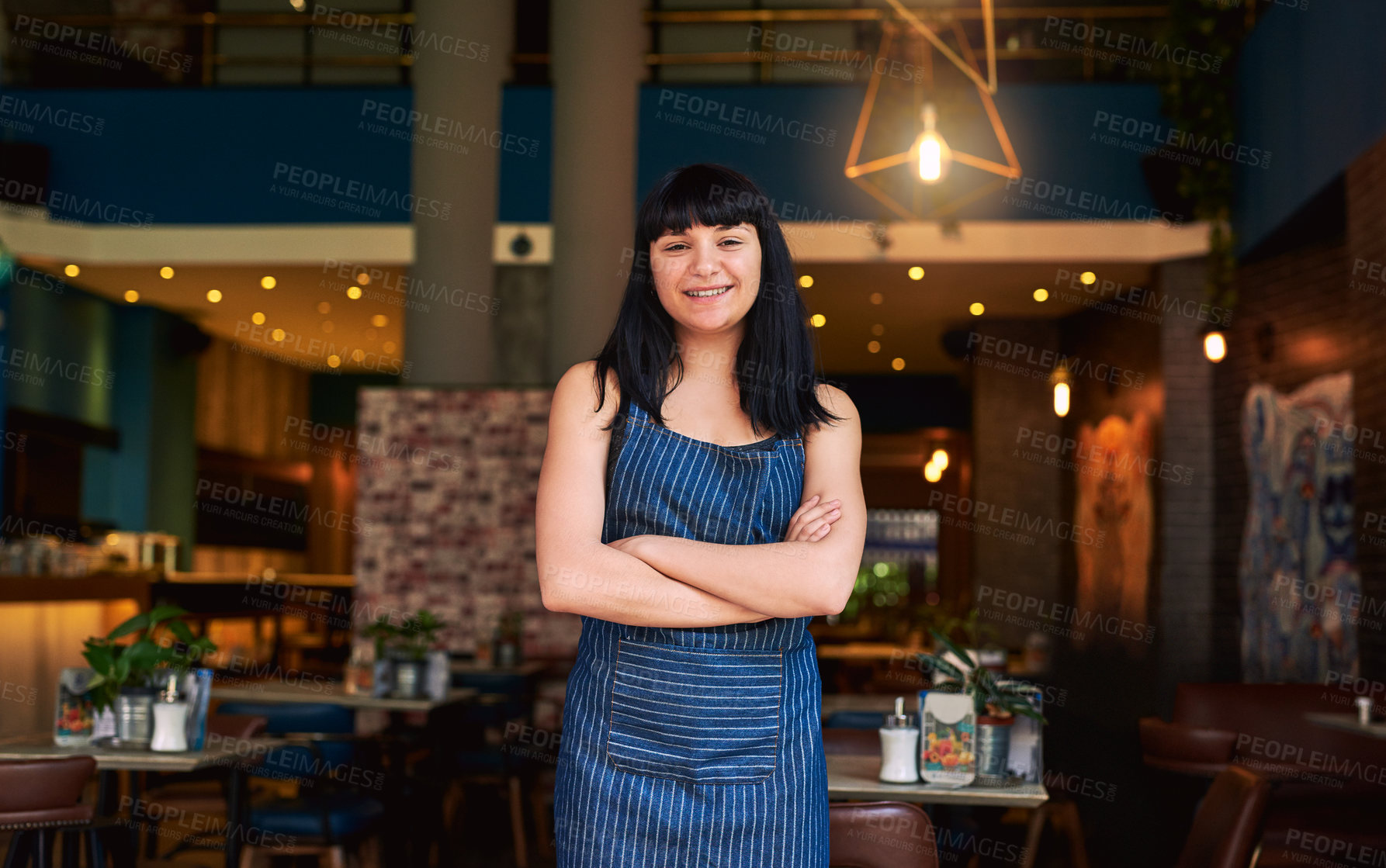 Buy stock photo Shot of a waitress standing at the entrance of a bar