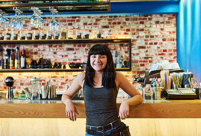 Buy stock photo Shot of a waitress standing by the counter at a bar
