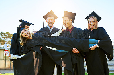 Buy stock photo Portrait of a group of students having fun on graduation day