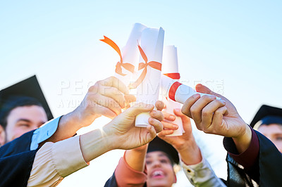 Buy stock photo Shot of a group of students holding their diplomas together on graduation day