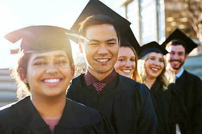 Buy stock photo Portrait of a group of students standing in a line on graduation day