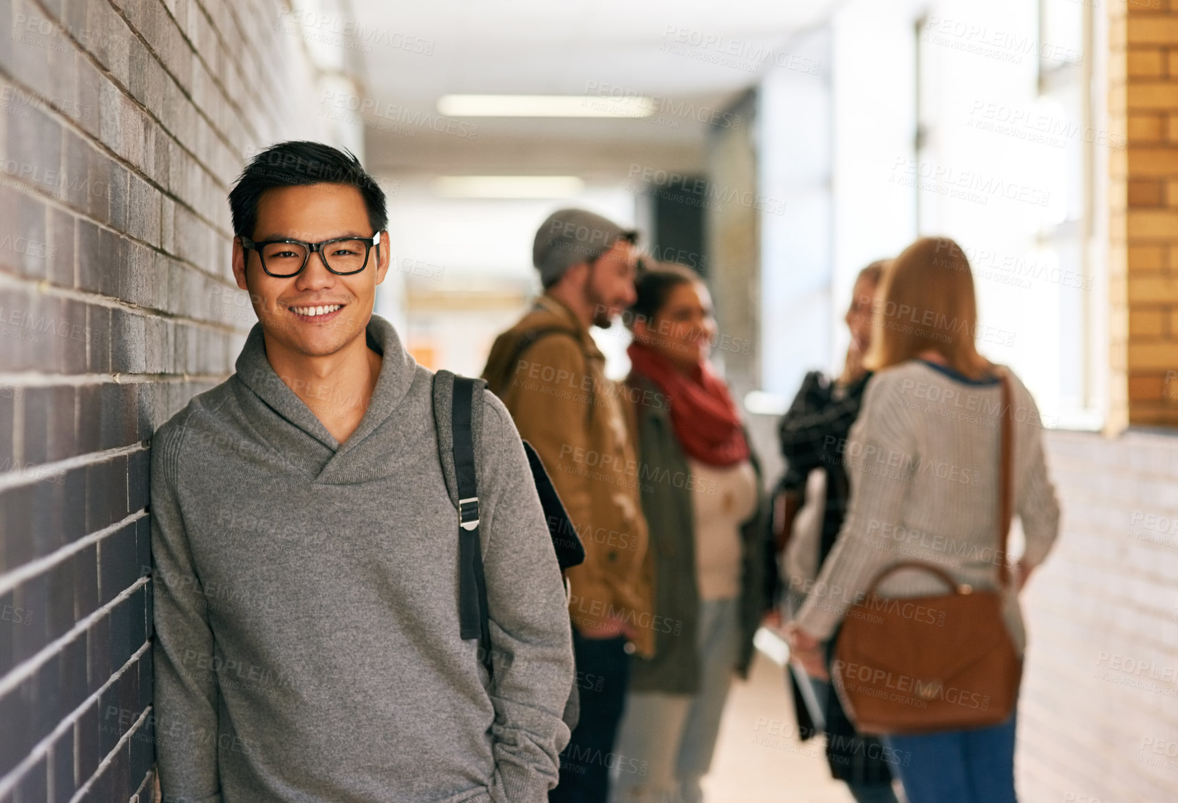 Buy stock photo Student, man and portrait in hallway of university or college for scholarship, higher education and learning knowledge. Male learner, happy and corridor on campus for study of english literature