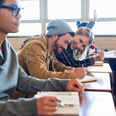 Buy stock photo Cropped shot of a group of university students working in class while sitting in a lecture