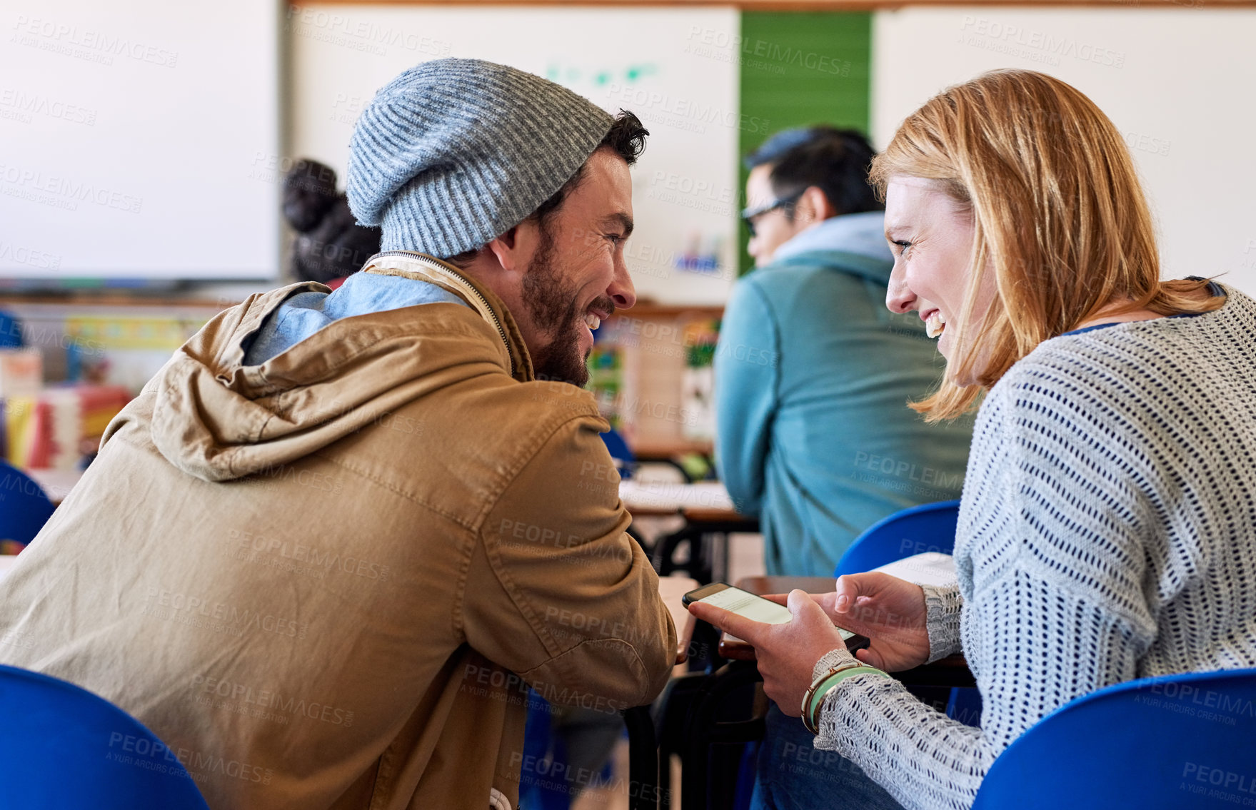 Buy stock photo Back, talking and people as university student in classroom, lecture and conversation with smartphone. Man, woman and happy for scholarship, education or knowledge as scholar at college campus in USA