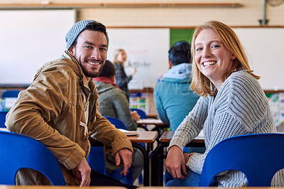 Buy stock photo Rearview portrait of two young university students sitting in class during a lecture