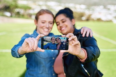 Buy stock photo Shot of female friends taking a picture together outside