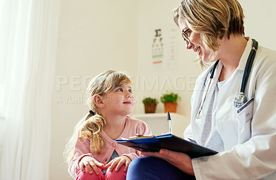 Buy stock photo Shot of a doctor having a consultation with a little girl in her consulting room