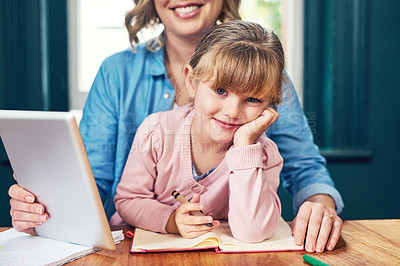 Buy stock photo Portrait of a cheerful little girl sitting down with her face resting on her hand while looking at the camera