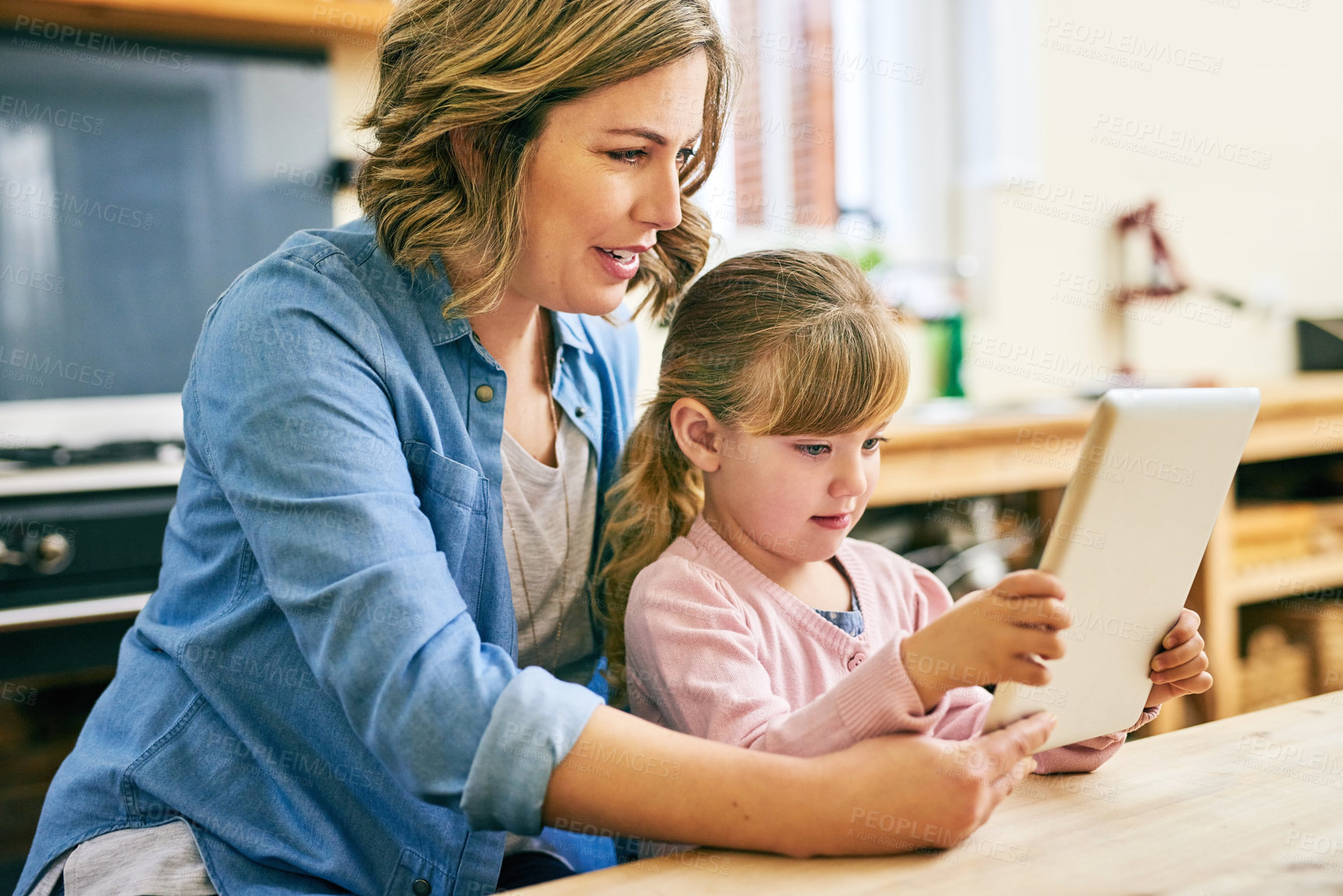 Buy stock photo Education, reading on tablet and mother with daughter in dining room of apartment for distance learning. Homeschool information or research with girl kid and parent for development, growth or memory