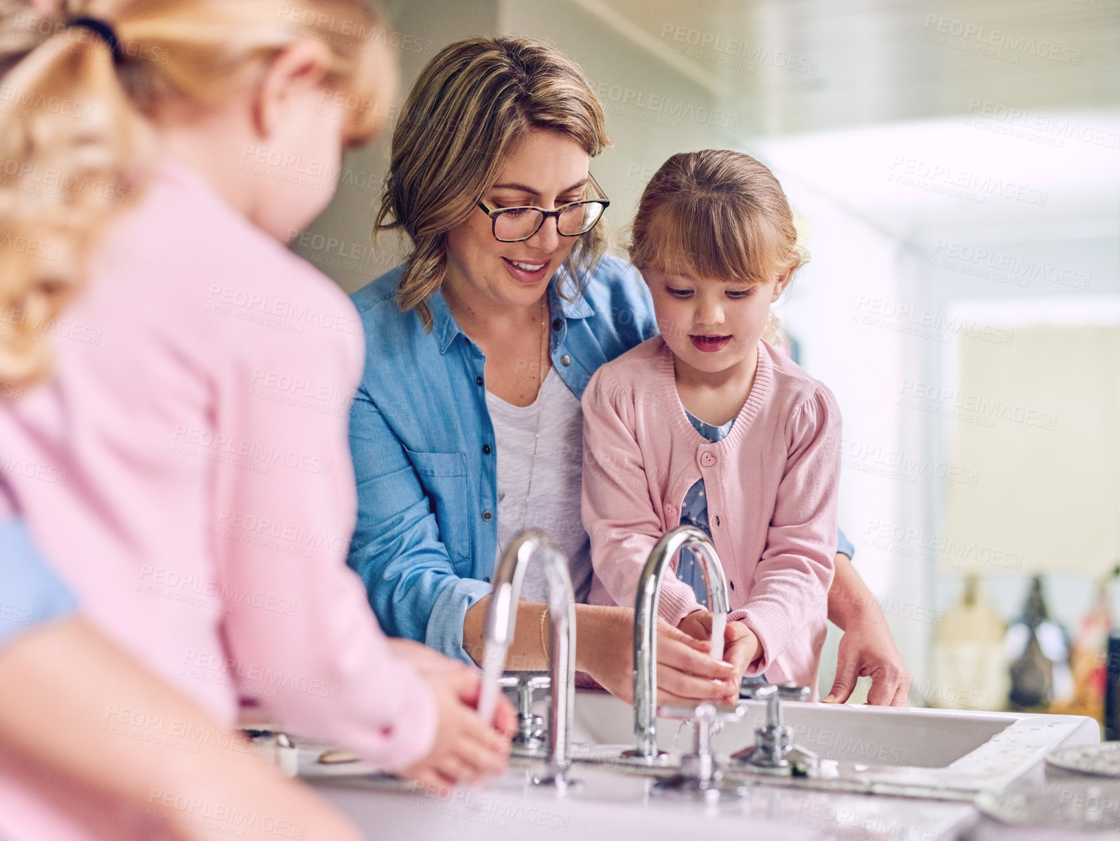 Buy stock photo Woman, teaching and child for washing hands with learning, growth and development in home. Mother, daughter and education in bathroom for hygiene, motor skills and cleaning with care, kid or bonding