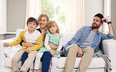 Buy stock photo Shot of a mother and children while the father stares at them with disdain at home