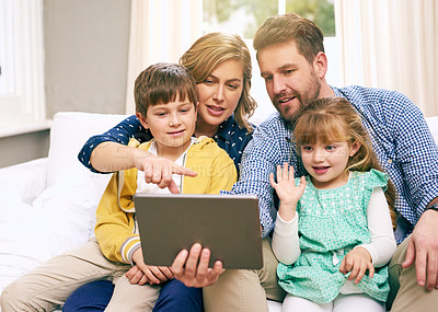 Buy stock photo Shot of a family using a tablet together at home