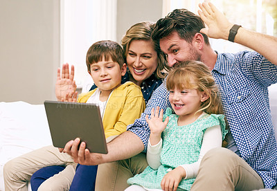 Buy stock photo Shot of a family using a tablet together at home