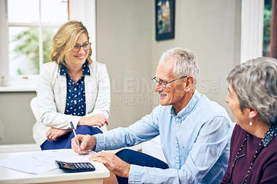 Buy stock photo Shot of a young insurance rep presenting a product to elderly clients in their home
