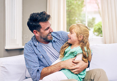 Buy stock photo Shot of a young father and his daughter bonding at home