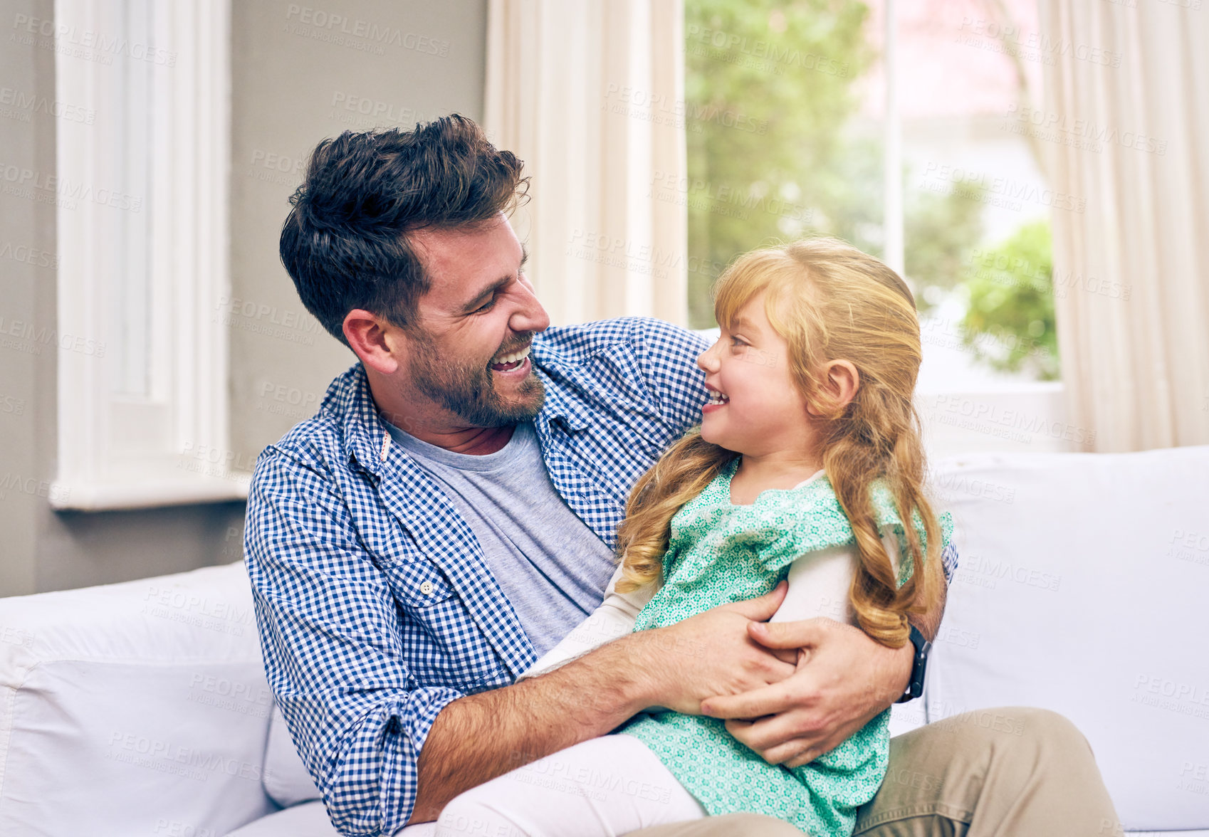 Buy stock photo Shot of a young father and his daughter bonding at home
