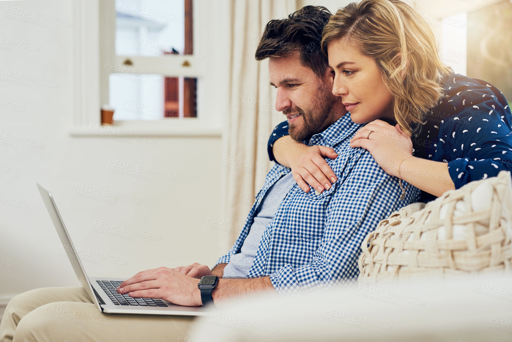Buy stock photo Shot of an attractive couple using a laptop together at home