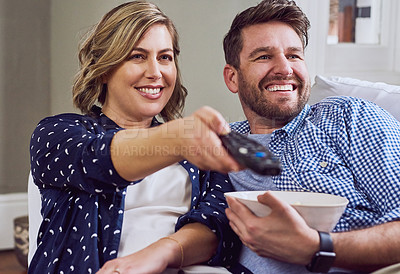 Buy stock photo Shot of an attractive couple watching a movie together at home