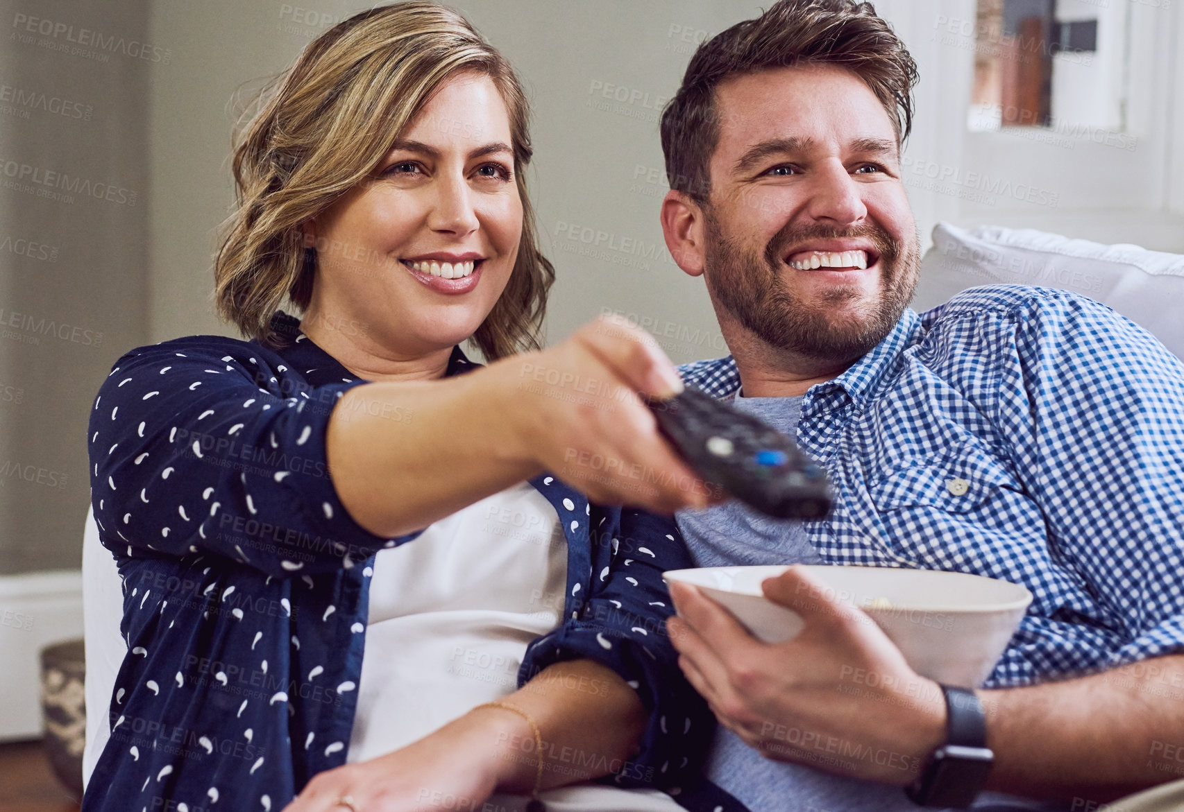 Buy stock photo Shot of an attractive couple watching a movie together at home