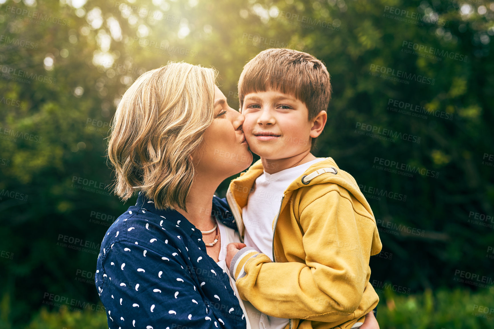 Buy stock photo Mother, happy son and outdoor portrait with kiss, vacation and support in relationship connection. Boy, mom and together for security embrace in countryside, trust and affection in England for peace