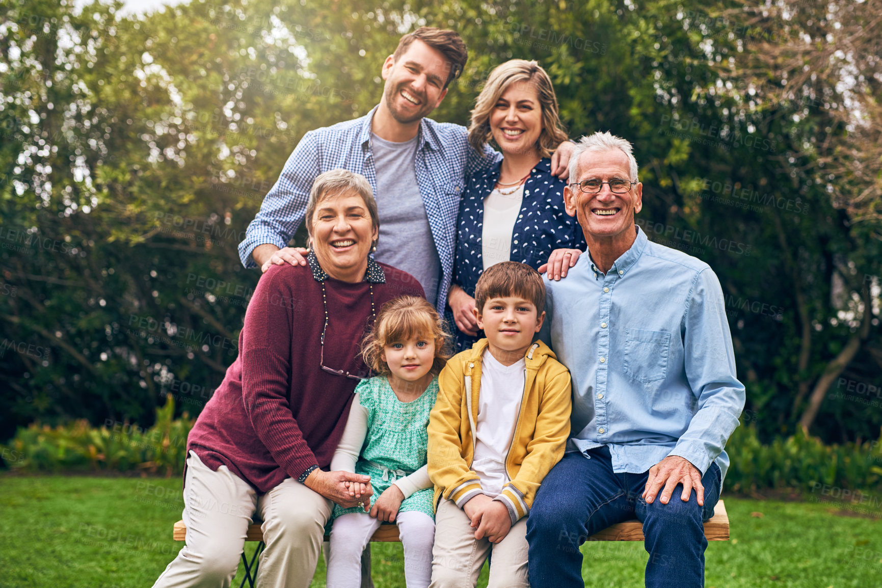 Buy stock photo Family, generations and outdoor portrait to relax, bench and support in relationship connection. Grandparents, parents and together for security embrace in countryside, vacation and travel to England